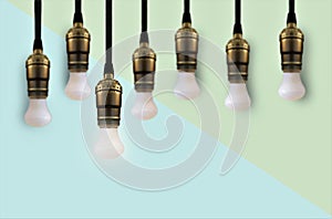 Idea concept with light bulb or Hanging light bulbs with glowing one different idea