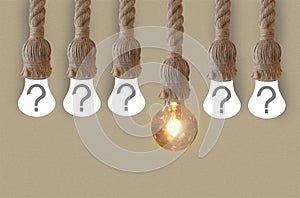 Idea concept with light bulb or Hanging light bulbs with glowing one different idea