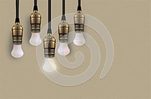 Idea concept with light bulb or Hanging light bulbs with glowing one different idea