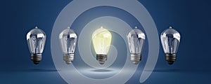 Idea concept with row of light bulbs and glowing bulb 3d illustration on blue