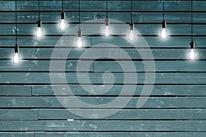 Idea concept - Vintage incandescent bulbs on blue wooden wall