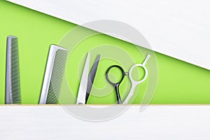 Idea of a green and gray background with a comb and scissors for a hairdresser