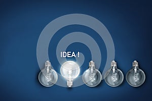 Idea , illuminated light bulb row dim ones concept solution