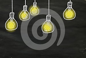 Idea,innovation,start up,solution and creativity concept. Light bulbs on black board, design template large copy space