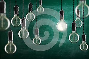 Idea and leadership concept Vintage incandescent Edison bulbs on color background