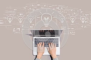 Idea light bulb theme with person using laptop