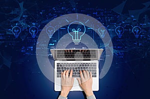 Idea light bulb theme with person using laptop