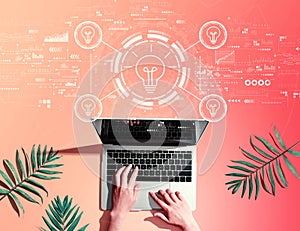 Idea light bulb theme with person using a laptop