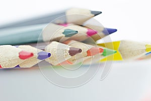 Idea from multicolored pencils isolated on white background.
