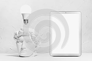 Idea of research of solution, brainstorming and thinking - glow light bulb over head of white antique statue David with intense.