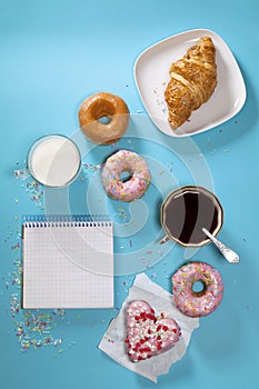 Ideal breakfast for the proper energy for the full day. Fresh coffee with milks and donuts . Hipster pictures. Top view