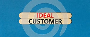Ideal customer symbol. Concept words Ideal customer on beautiful wooden stick. Beautiful blue table blue background. Business