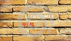 Ideal customer symbol. Concept words Ideal customer on beautiful brick wall. Beautiful red brown brick wall background. Business