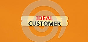 Ideal customer symbol. Concept words Ideal customer on beautiful wooden stick. Beautiful orange table orange background. Business