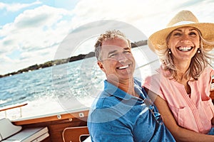 The ideal vacation for water lovers. Portrait of a mature couple enjoying a relaxing boat ride.