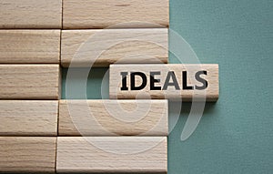 Ideals symbol. Wooden blocks with word Ideals. Beautiful grey green background. Business and Ideals concept. Copy space