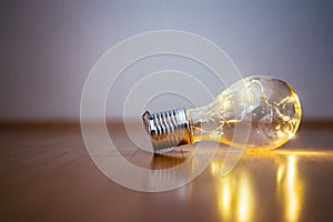 Ideas and innovation: Light bulb with LEDs is lying on the wooden floor. Copy space
