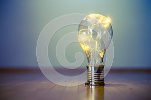 Ideas and innovation: Light bulb with LEDs is lying on the wooden floor. Copy space