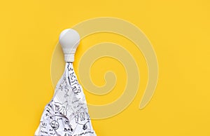 Ideas,inspiration concepts with rocket light bulb and sketch paper on yellow background