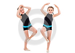 Identical twin girls practice and doing rhythmic gymnastics, white background