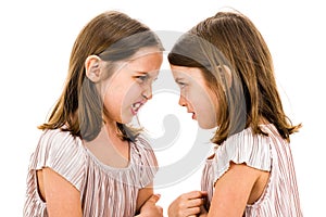 Identical twin girls sisters are arguing yelling at each other