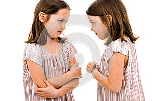 Identical twin girls sisters are arguing yelling at each other