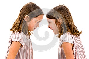 Identical twin girls sisters are arguing yelling at each other