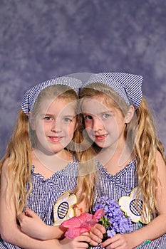 Identical twin sisters holding