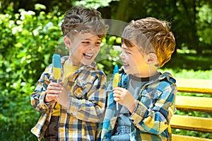 Identical twins with lollipops