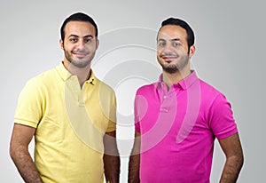 Identical twins portraits shot against white background photo