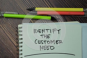 Identify The Customer Need write on a book isolated on office desk