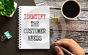 Identify The Customer Need write on a book isolated on office desk