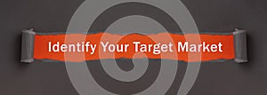 Identify Your Target Market - text appearing behind torn brown paper. Motivation quote