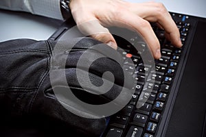 Identity theft with hands on laptop computer