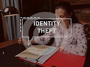 IDENTITY THEFT text in block of quotes. Businesswoman doing paperwork