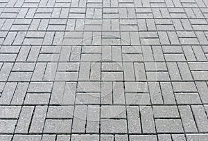 idewalk tiles. Closeup of paving slabs background. Street paving slabs. Cement block of the road. Cement brick squared stone floor