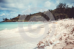 Idilic white sand beach with green hill at the back in Hawaii, US