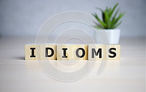 Idioms word concept on cubes, jargon concept.