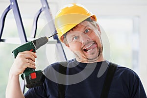 Idiot worker using electric drill portrait