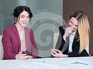 Idle worker mobile phone laugh business women
