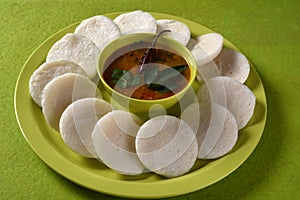 Idli with Sambar in bowl on green background, Indian Dish : south Indian favourite food rava idli or semolina idly or rava idly,