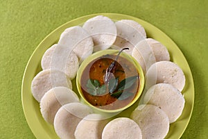 Idli with Sambar in bowl on green background, Indian Dish : south Indian favourite food rava idli or semolina idly or rava idly,