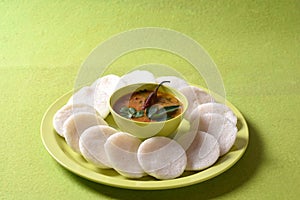 Idli with Sambar in bowl on green background, Indian Dish : south Indian favourite food rava idli or semolina idly or rava idly,