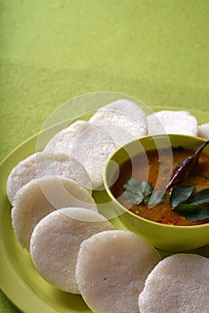 Idli with Sambar in bowl on green background, Indian Dish : south Indian favourite food rava idli or semolina idly or rava idly,