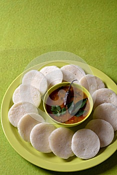 Idli with Sambar in bowl on green background, Indian Dish : south Indian favourite food rava idli or semolina idly or rava idly,