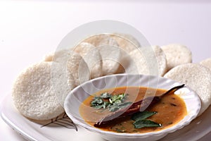 Idli with Sambar in bowl on white background, Indian Dish