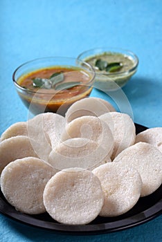 Idli with Sambar and coconut chutney on blue background, Indian Dish