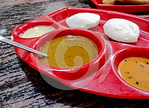 Idli Sambhar or Idly Sambar is a popular south Indian food, served with coconut chutney. selective focus