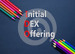 IDO initial DEX offering symbol. Concept words IDO initial DEX offering on beautiful black paper. Beautiful black background.