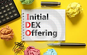 IDO initial DEX offering symbol. Concept words IDO initial DEX offering on beautiful white note. Beautiful yellow background.